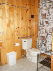 Cabin #14's main bathroom with tub/shower combination and decorated in "Up North" theme.  This bathroom is located off of the living room area; the 2nd bathroom is located off of the kitchen area.