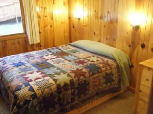 Cabin #15 has Queen beds in 3 bedrooms.  The 4th bedroom has bunk beds.  All bedrooms have dressers and closets.  