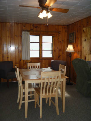 Dining table sits directly adjacent to the living room.  The living room, with big picture windows, faces the lake.  Great location!