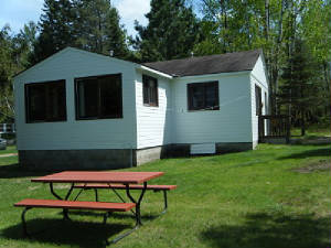 Outside Cabin 8 with grill & picnic table