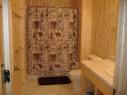 Cabin Bathroom with tub/shower combination.  This bathroom is located across from the Sunroom at the South End of the cabin.  The 2nd Bathroom is located off of the Dining area at the North end of the Cabin.  