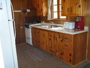 Cabin 5 Kitchen stocked with dishes, pots, pans, coffee maker, microwave & full size appliances